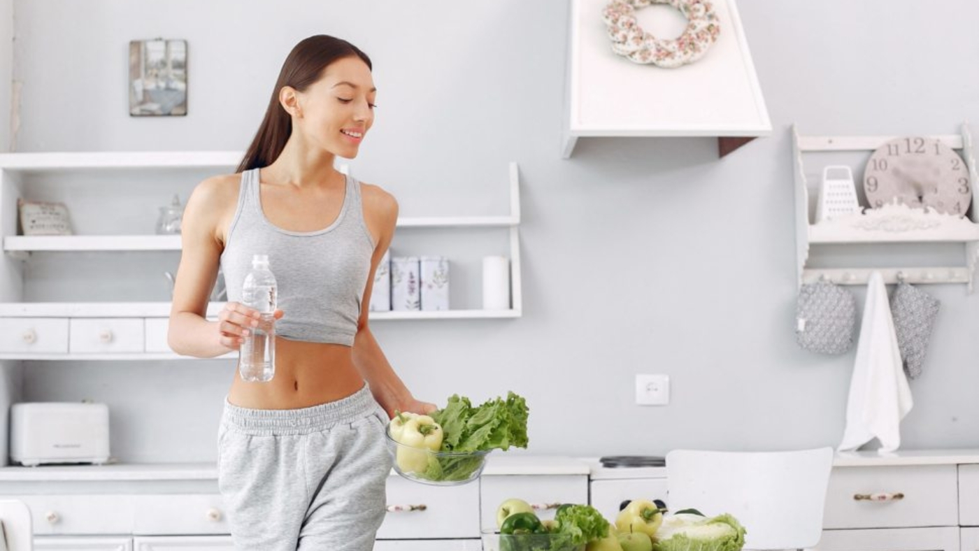 Healthy eating. Dieting and people concept. Brunette with a vegetable.